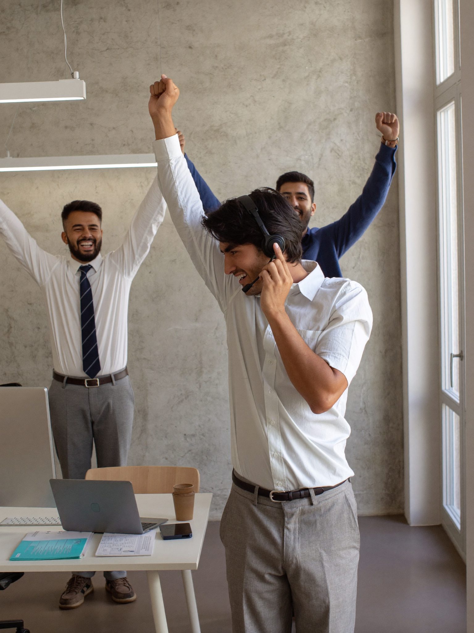 A rep doing a victory dance while colleagues cheer
